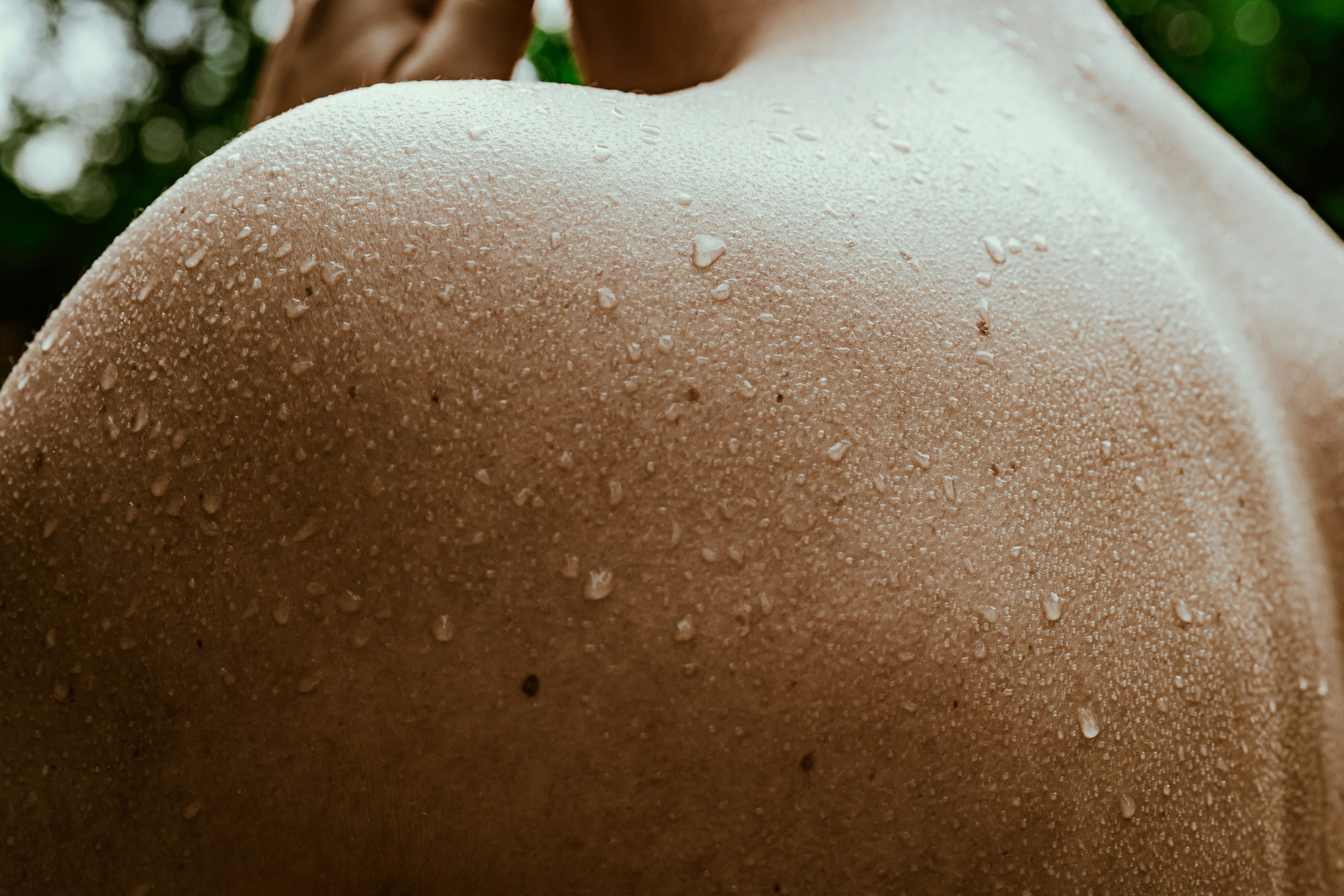 Close-up of a wet shoulder, evoking the refreshing balance of acupuncture therapies.