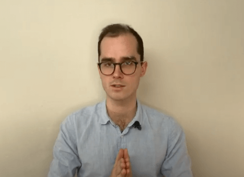 A man in glasses and a light shirt sits calmly, suggesting a TCM consultation setting.