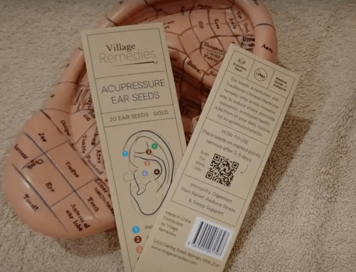 Acupressure ear seeds kit with TCM instructions shown on a tray displaying an ear diagram.